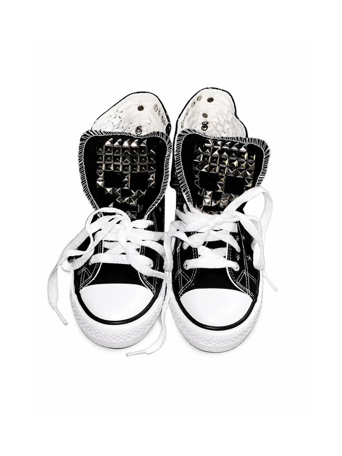 Black studded high-top sneakers front top view with skull tongue studs and white laces