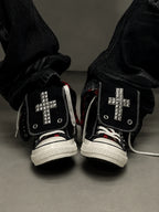 Red check cross studded high-top sneakers worn front view