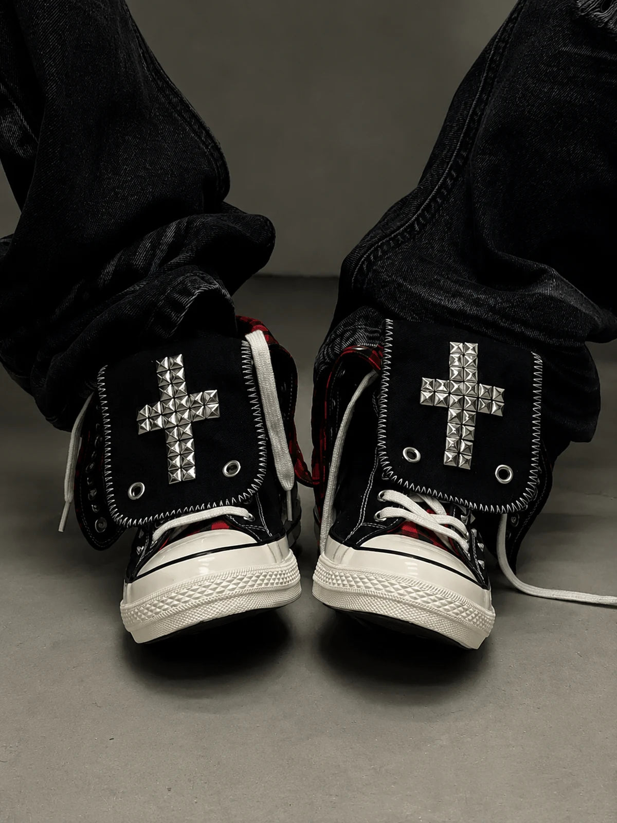 Red check cross studded high-top sneakers worn front view