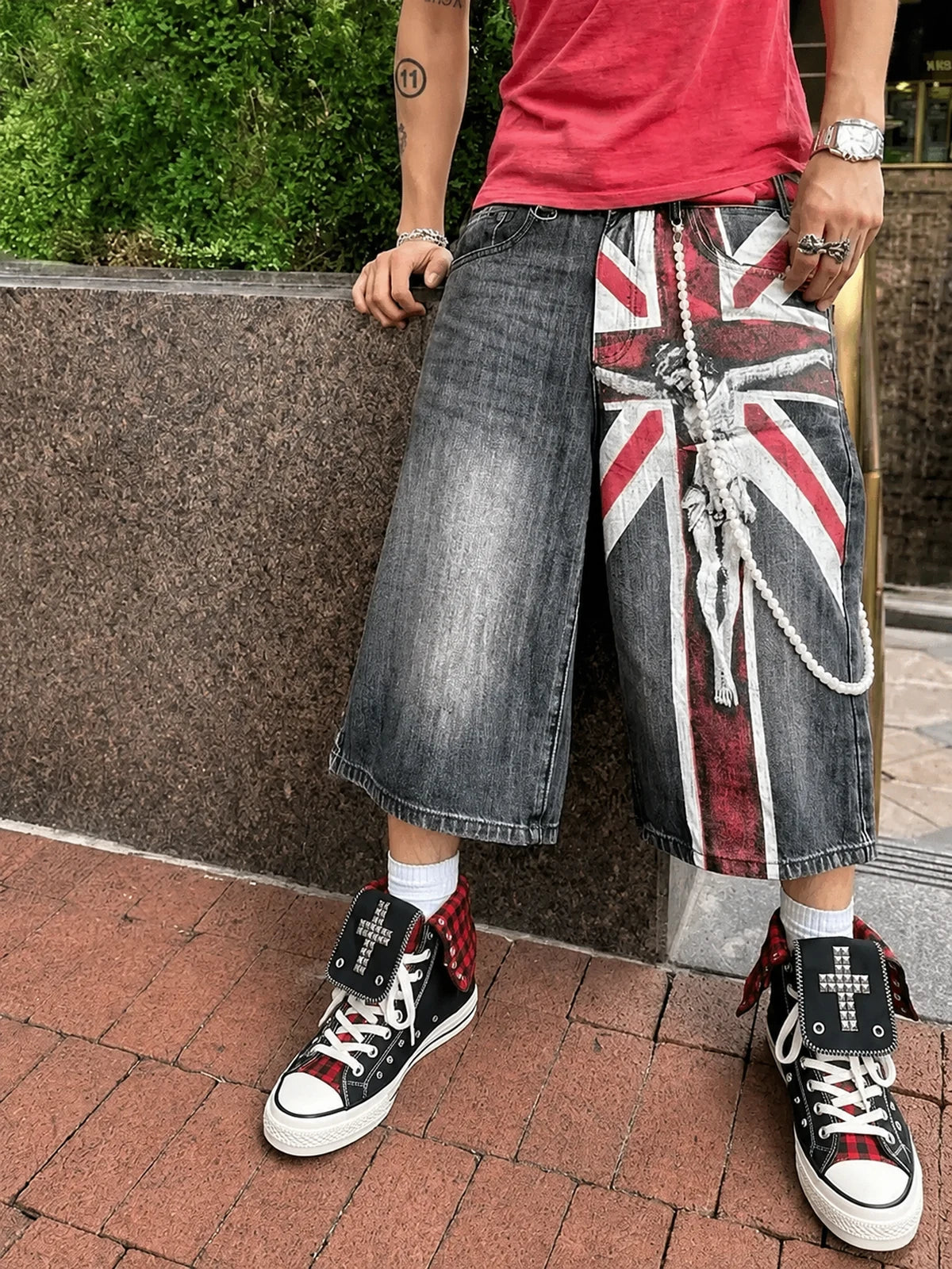 Red check cross studded high-top sneakers styled with wide shorts