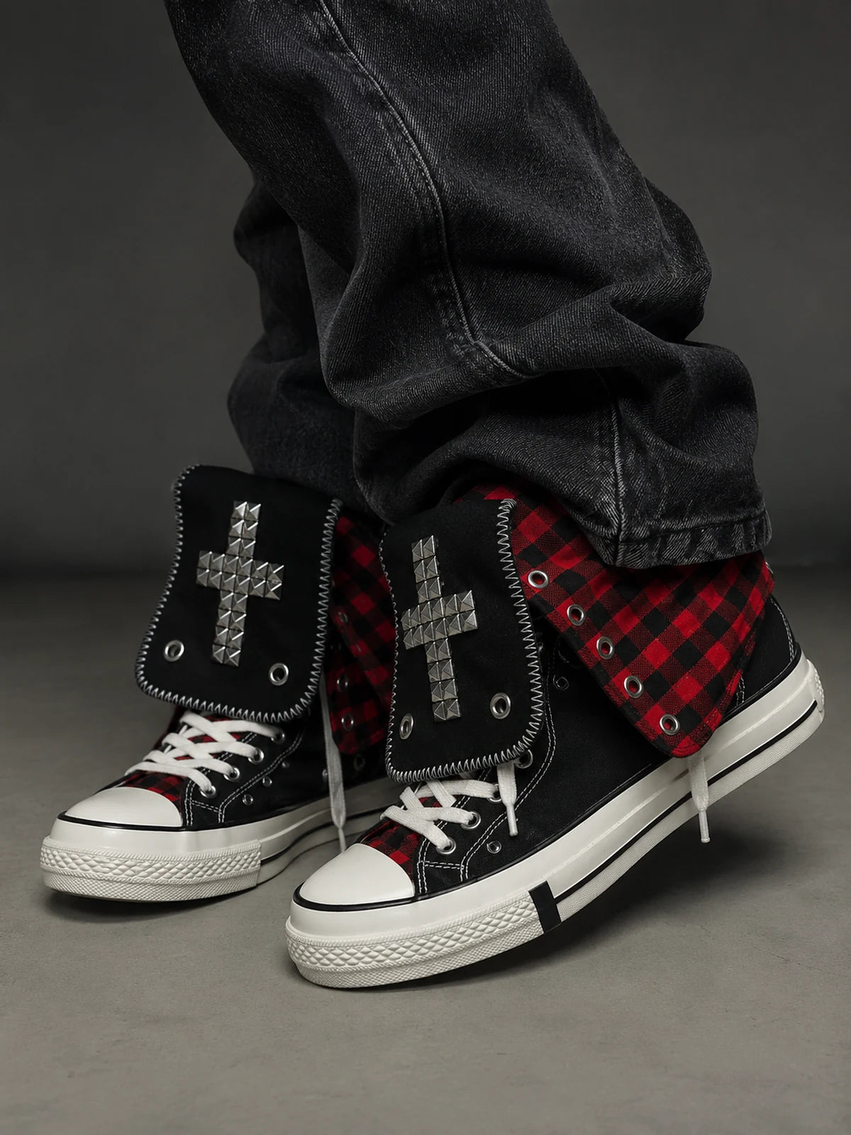Red check cross studded high-top sneakers worn side view