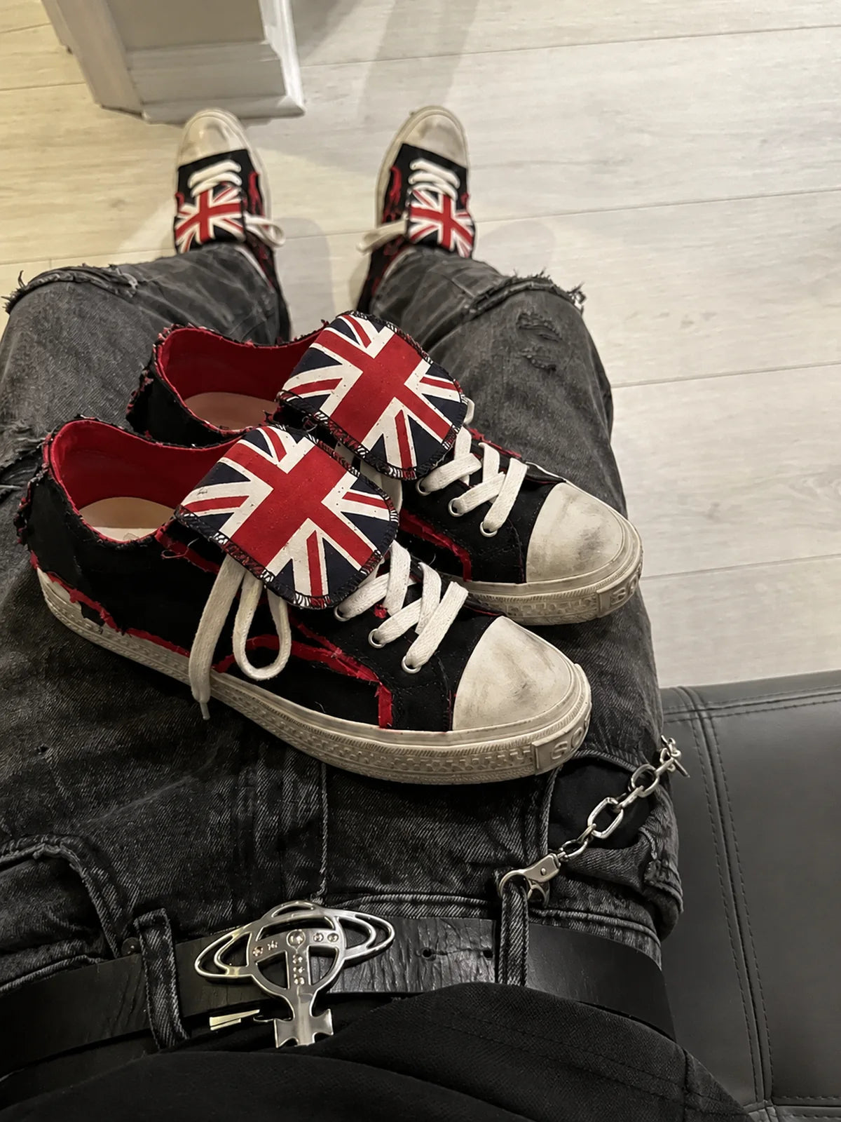 Black red distressed low-top sneakers lap close-up