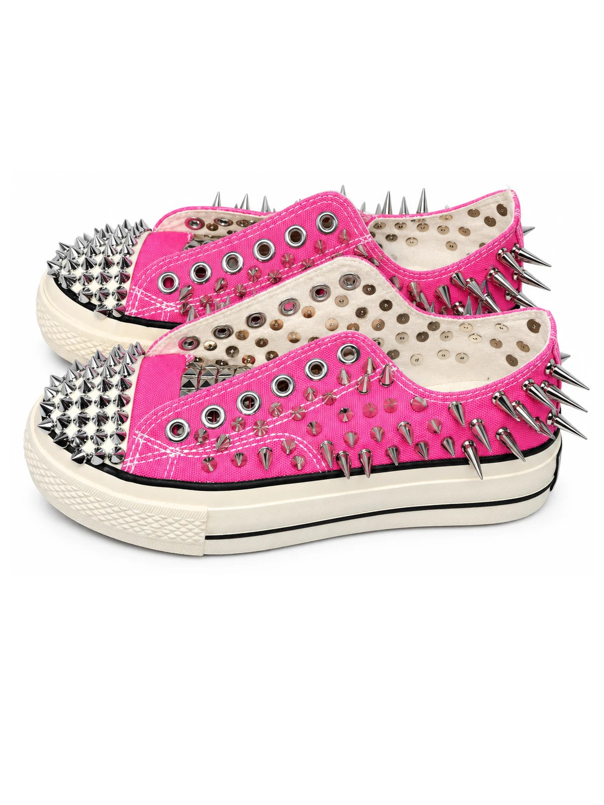 Pink spiked low-top sneakers three-quarter pair view on white background