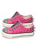 Pink spiked low-top sneakers side pair view on white background