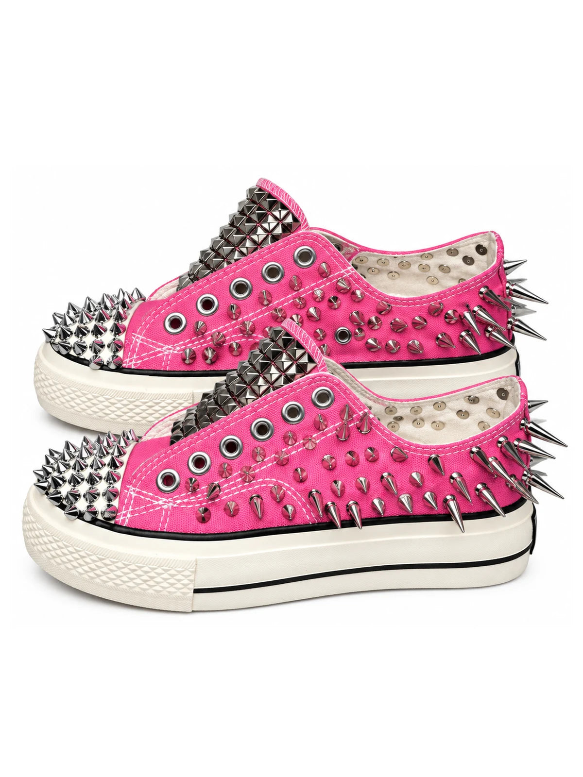 Pink spiked low-top sneakers side pair view on white background