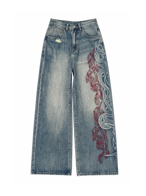 The "Tribal Flame" Embroidered Jeans in blue on a white background, front view