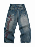 The Tribal Flame Embroidered Jeans in blue, natural flat lay on a pure white background, back view