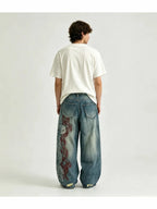 The "Tribal Flame" Embroidered Jeans in blue, studio back view