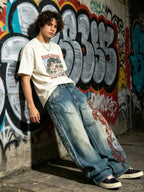 The "Tribal Flame" Embroidered Jeans styled on model, graffiti wall front view