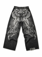 The Skeletal Wings Distressed Jeans in washed black, natural flat lay on a pure white background, back graphic view