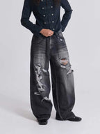 The Skeletal Wings Distressed Jeans styled on model, studio full-body front view