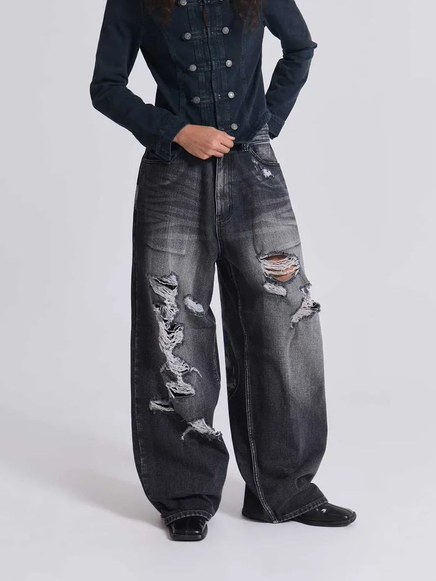 The Skeletal Wings Distressed Jeans styled on model, studio full-body front view