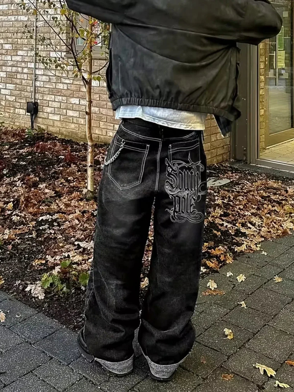 The Polar Script Washed Jeans in black, outdoor autumn back-view styling