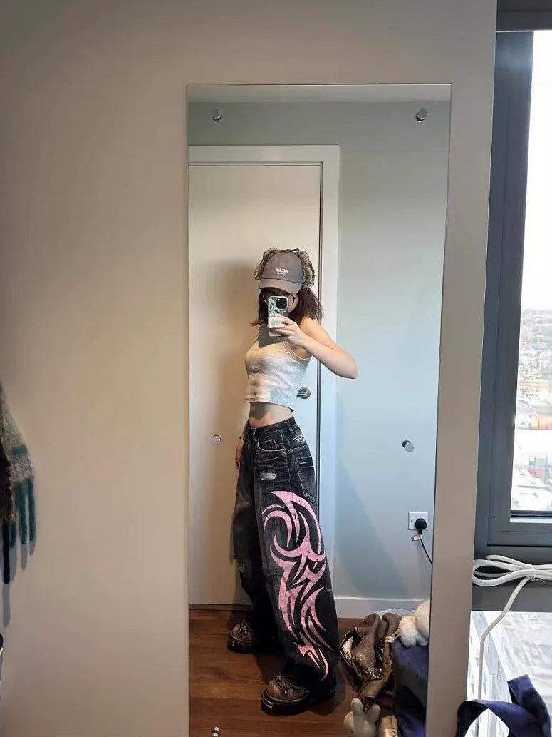 Black and pink Tribal Halo wide-leg jeans styled in a mirror photo