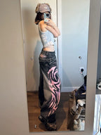Side view of black and pink Tribal Halo wide-leg jeans