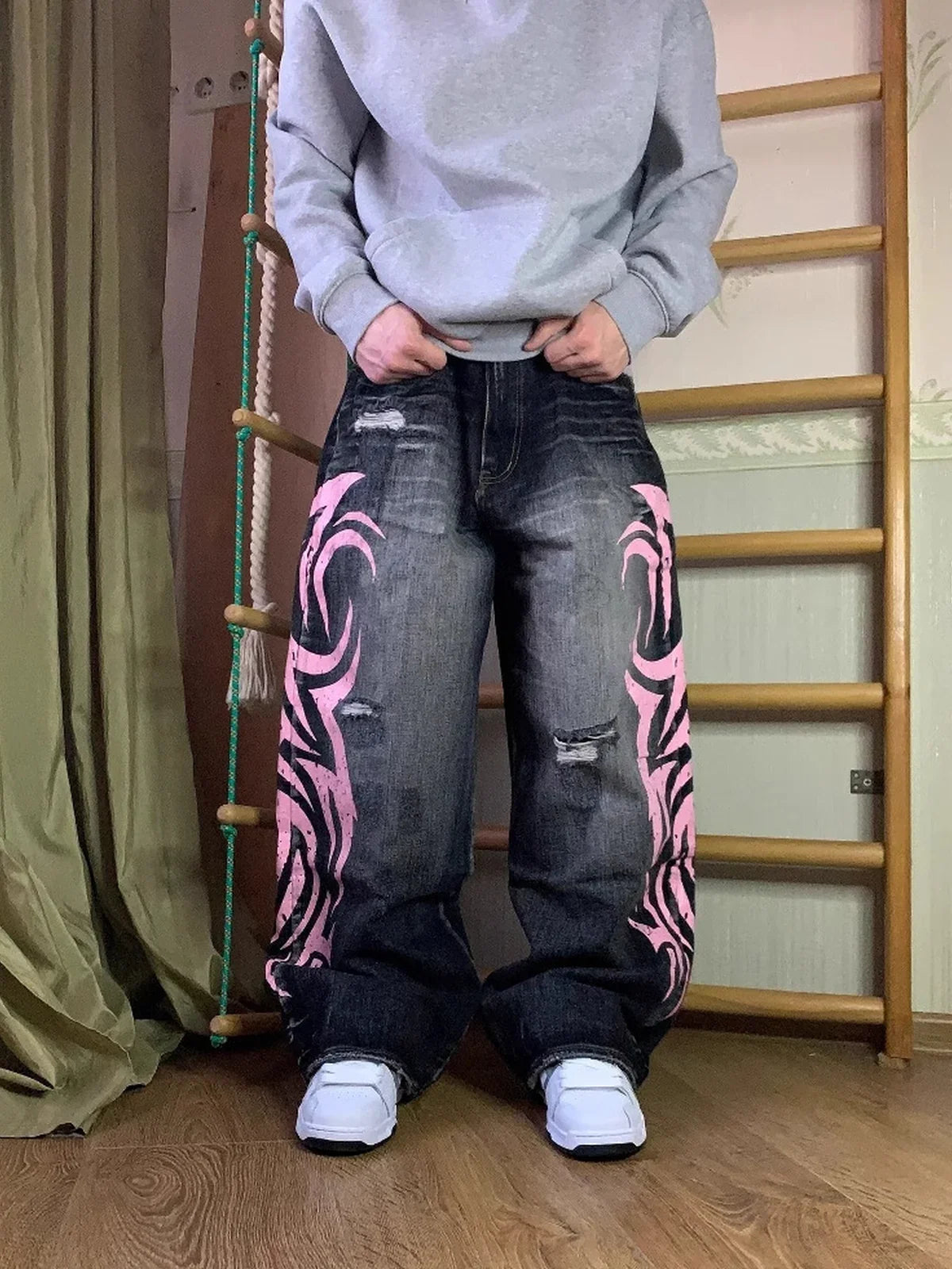 Black and pink Tribal Halo washed wide-leg jeans styled indoors, full front view