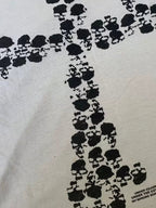 Close-up of the black skull cross print on white cotton jersey