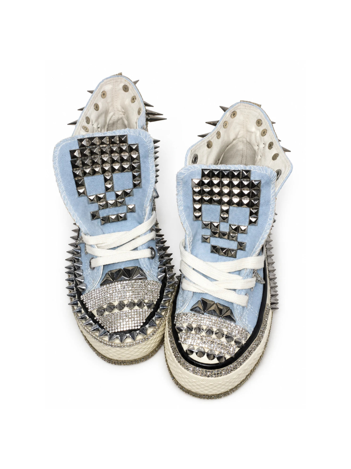 Baby-blue studded high-top sneakers with skull-studded tongues, front top view