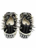 Black spiked low-top sneakers with heel spikes, back view