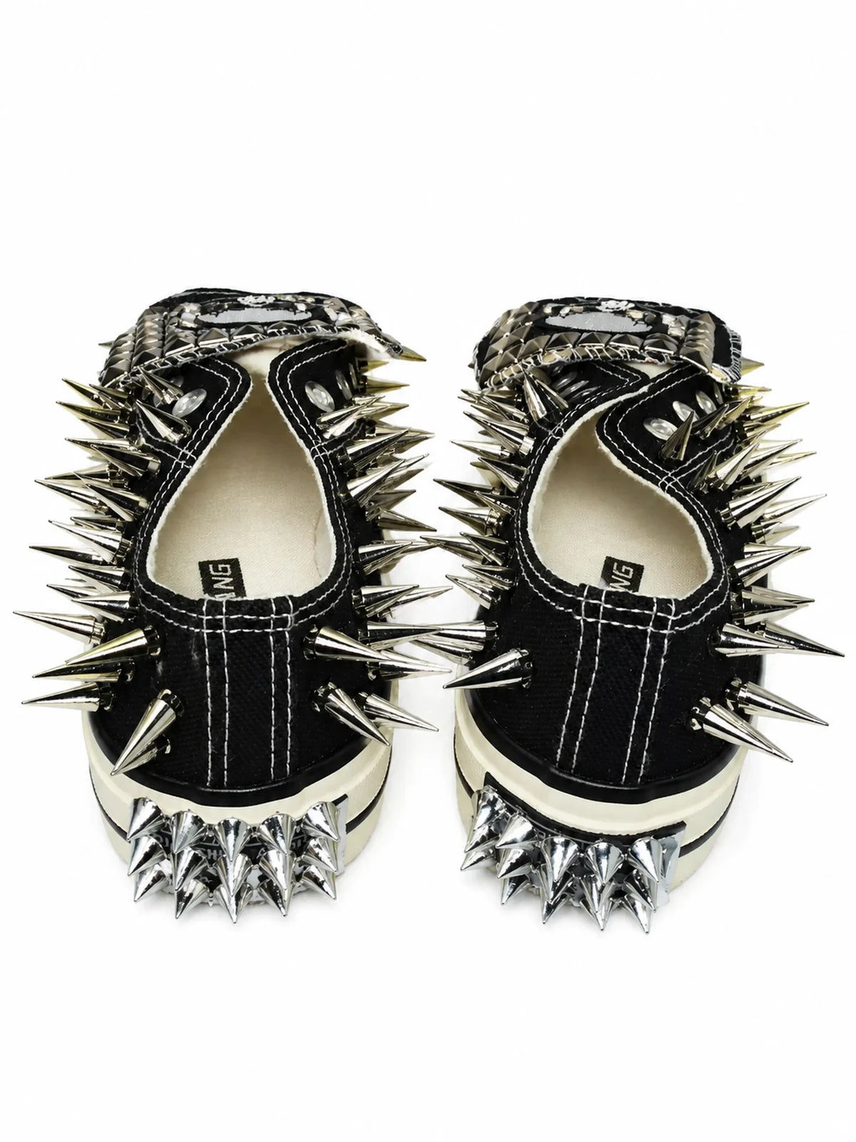 Black spiked low-top sneakers with heel spikes, back view